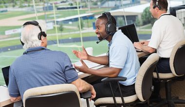 Group of sports reporters and commentators discussing football game